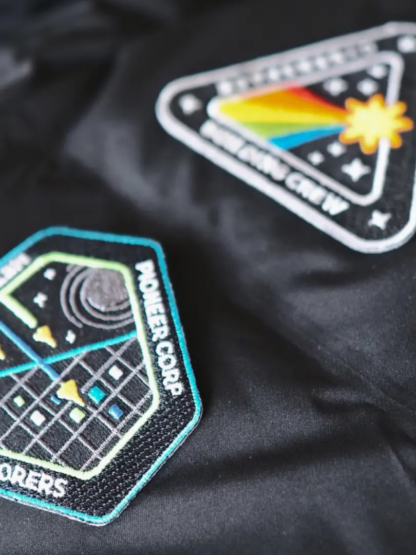 Close-up of colorful patches with space illustrations.